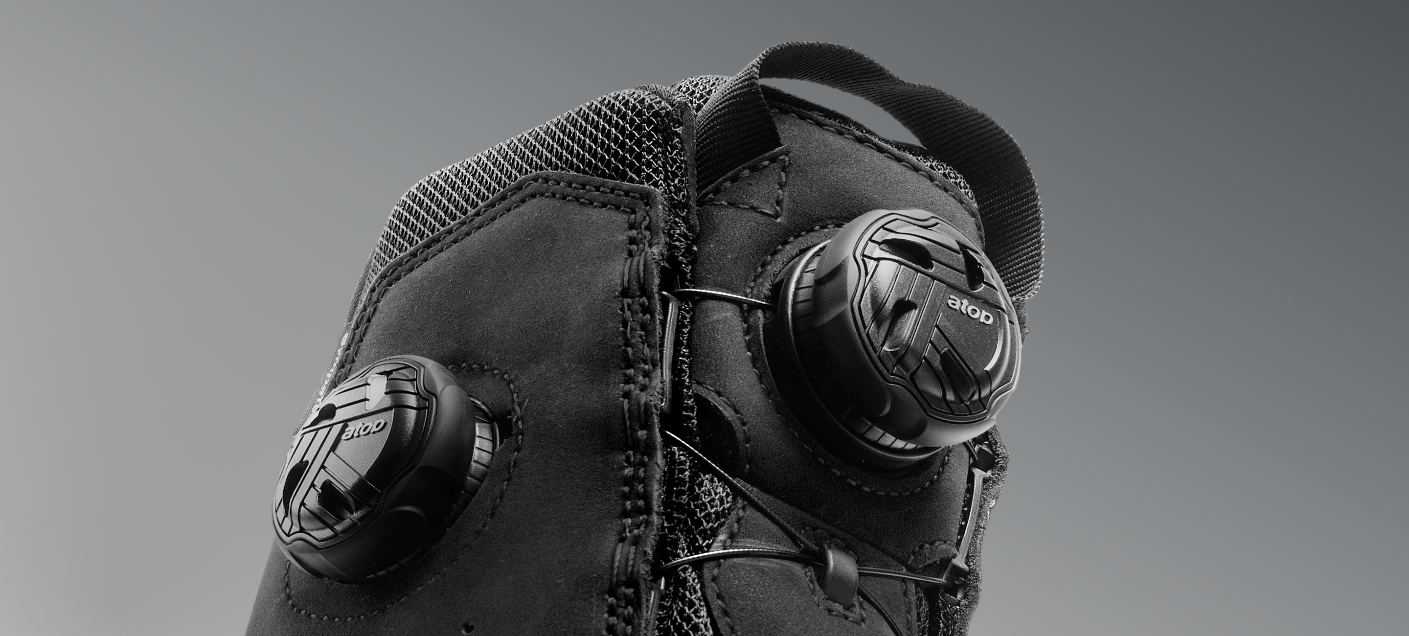 Black protective knee pad with padding on a gray background